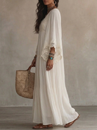 Model gracefully walking outdoors, highlighting the light and airy fall of the bohemian lace maxi dress.