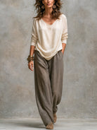 Side profile of a model in a neutral-toned longline jacket, emphasizing its comfortable and elegant drape.