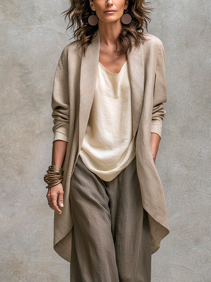 Detail shot of the soft, draped fabric of the open-front jacket, highlighting its subtle texture and quality.