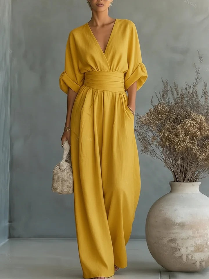Lifestyle shot of a woman confidently walking in a yellow jumpsuit, perfect for a stylish day out.