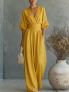 Lifestyle shot of a woman confidently walking in a yellow jumpsuit, perfect for a stylish day out.