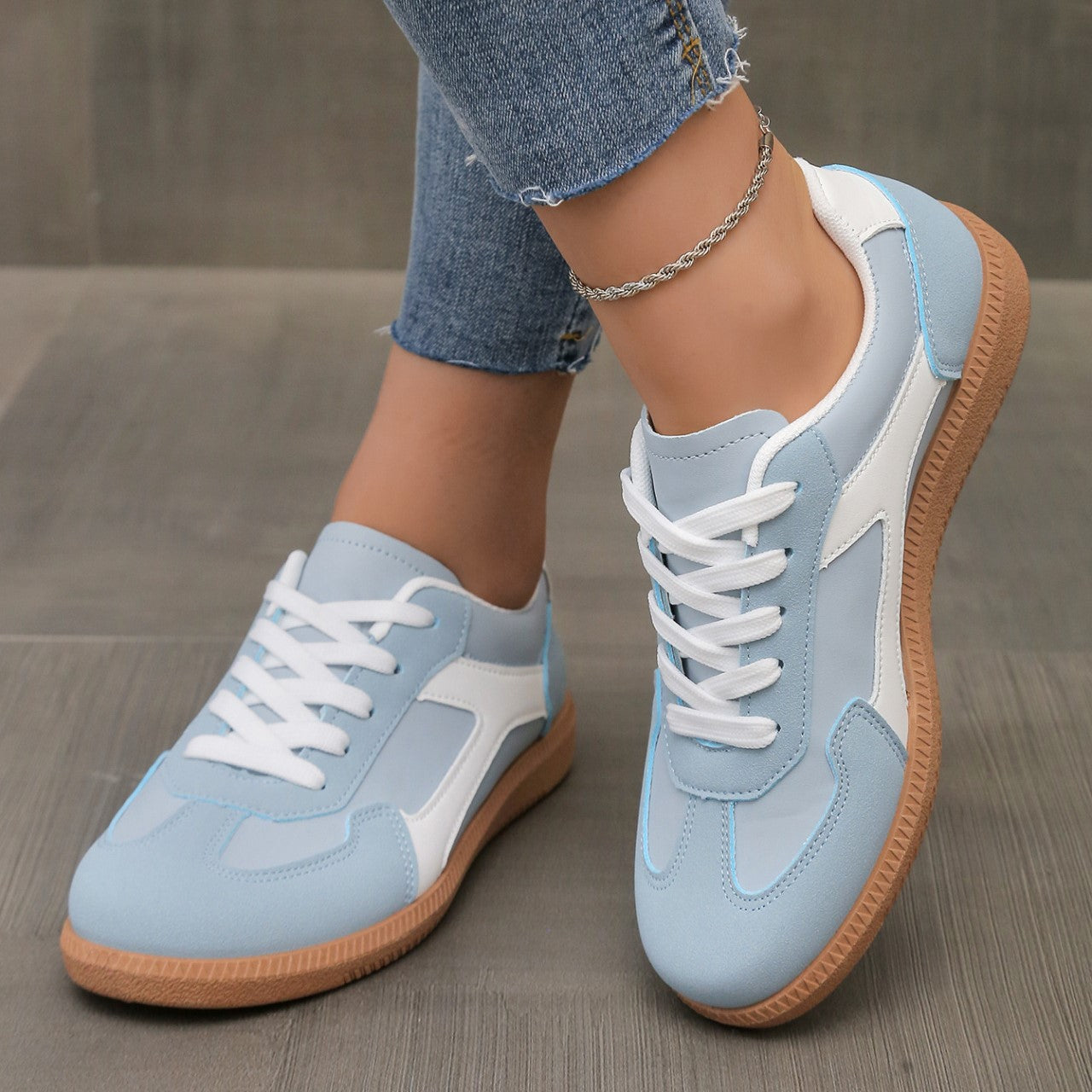 Close-up of the sky blue Adaline orthopaedic shoe, showing the breathable upper material and stitching details.