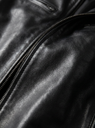 Side profile of the Alden leather jacket in dark brown, highlighting the tailored cut and quality stitching.