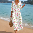 Front view of a woman wearing the Althea soft summer midi dress, showcasing its flattering silhouette and lightweight rose-print fabric.
