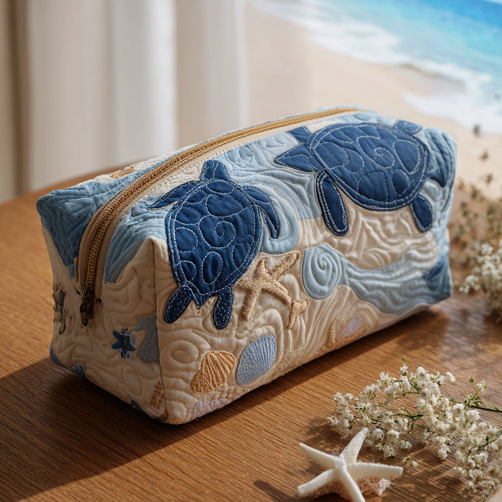 Front view of a Anouk quilted cosmetic bag featuring a vibrant blue shells pattern, showcasing its elegant texture and design.
