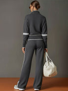 Lifestyle image of Anouk relaxed fit pants in a travel setting, suggesting their suitability for long journeys.