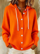 Woman wearing an orange Anouk T-shirt outdoors, demonstrating its versatility and relaxed appeal.