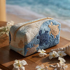 Close-up of a Calla artisanal quilted cosmetic bag in a charming Tartaruga Marina print, showcasing its soft texture and vibrant design.