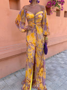 Close-up detail of the vibrant floral print on the light and airy fabric of the elegant maxi dress.