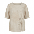 Close-up detail of the raised circular embroidery on the Seraphina casual top, highlighting its texture.