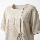Side profile of the Seraphina casual top, illustrating the relaxed fit and the asymmetric button placket.