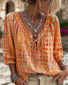 Full-length shot of a model wearing the Xylia blouse in teal, styled for a relaxed outdoor event.