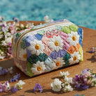 Front view of a Colette quilted cosmetic bag in a petal path print, showcasing its elegant design.