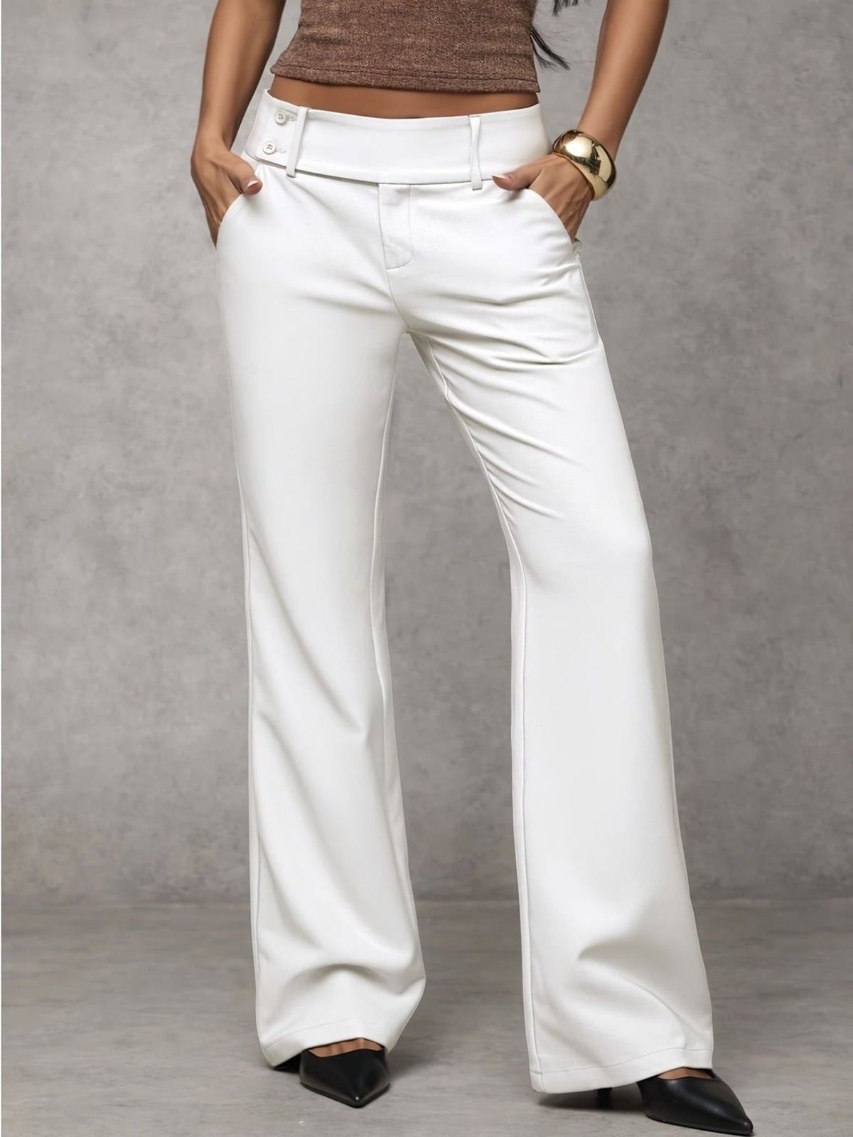 Full-length view of a woman walking in black elegant trousers, illustrating the smooth movement of the fabric.
