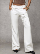 Full-length view of a woman walking in black elegant trousers, illustrating the smooth movement of the fabric.