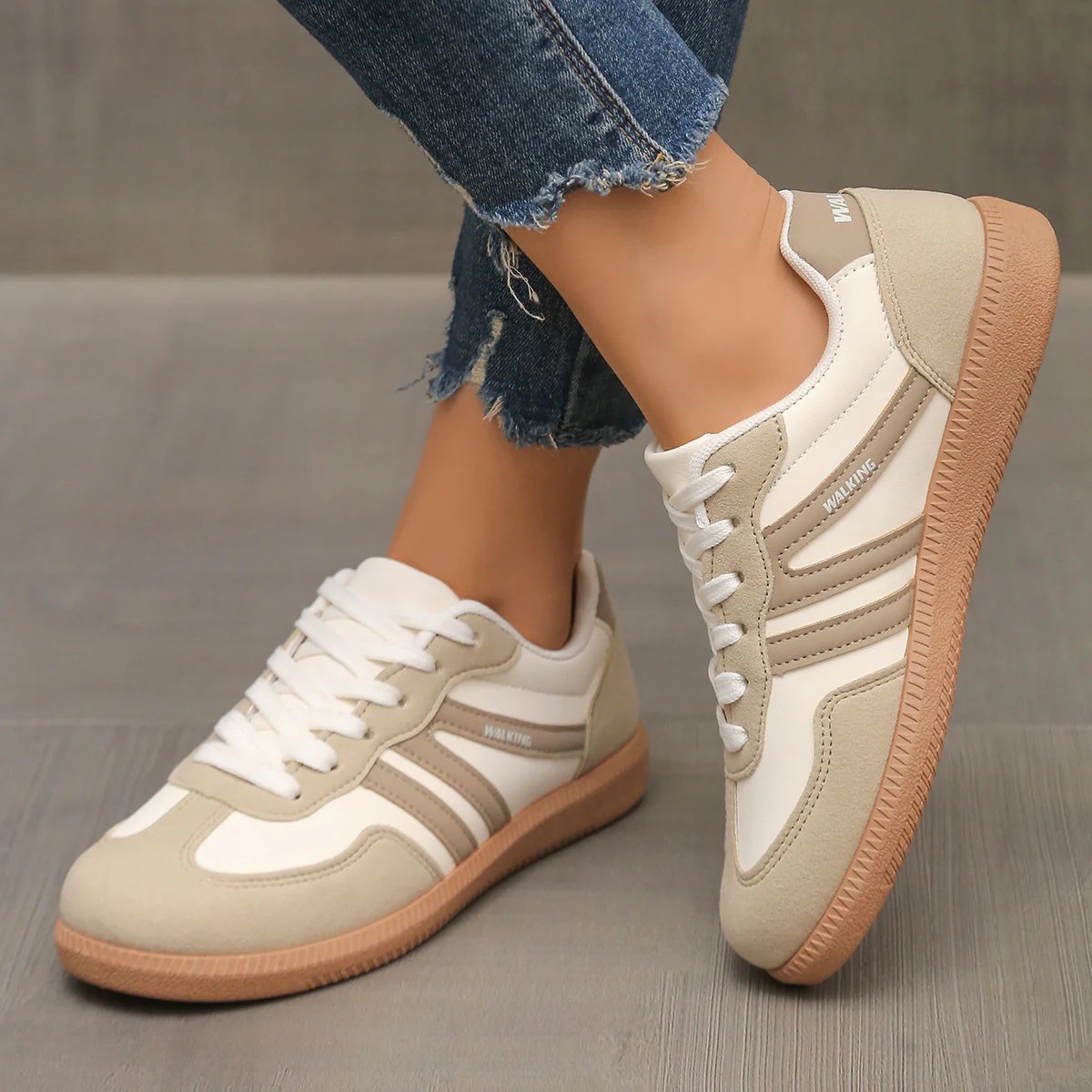 Side profile of an Elara orthopaedic cushioned trainer in off-white, showcasing its sleek design and supportive sole.