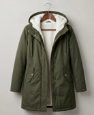 Lifestyle shot of a woman comfortably walking in the Elara parka during a brisk, rainy morning.
