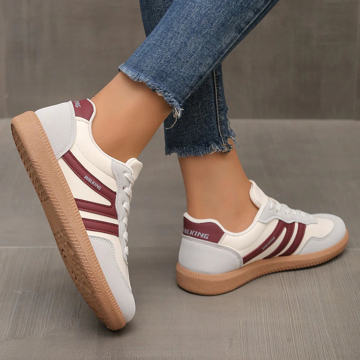 Side view of a wine red Elara orthopaedic cushioned trainer, presenting its rich color and ergonomic form.