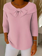 Close-up detail of the bow embellishment on the Elara knitted top, highlighting the fabric texture and craftsmanship.