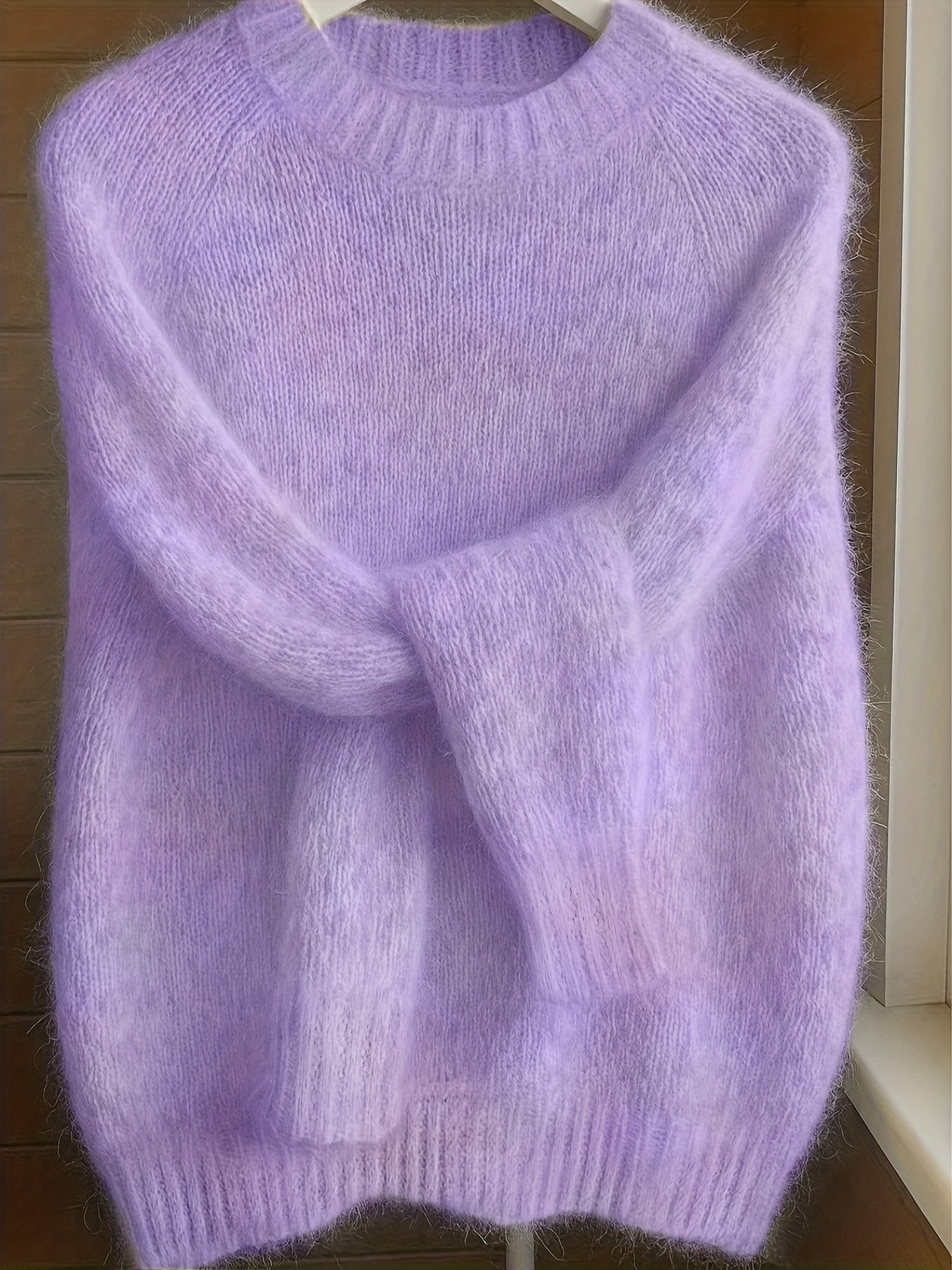 Close-up detail of the fine knit texture and luxurious feel of the purple Elara cashmere-blend sweater.