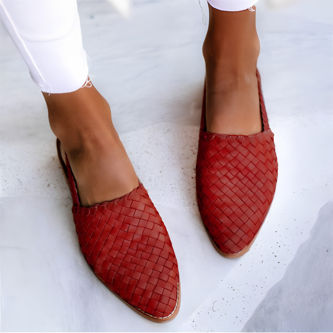 Close-up of the red handcrafted moccasins' woven pattern and stitching, emphasizing the quality of craftsmanship.