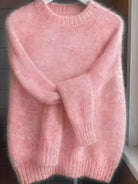 Back view of the soft pink Elara cashmere-blend sweater, showing the smooth fabric and flattering cut.