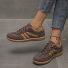 Pair of off-white Elara orthopaedic cushioned trainers displayed on a clean surface, emphasizing their modern aesthetic.