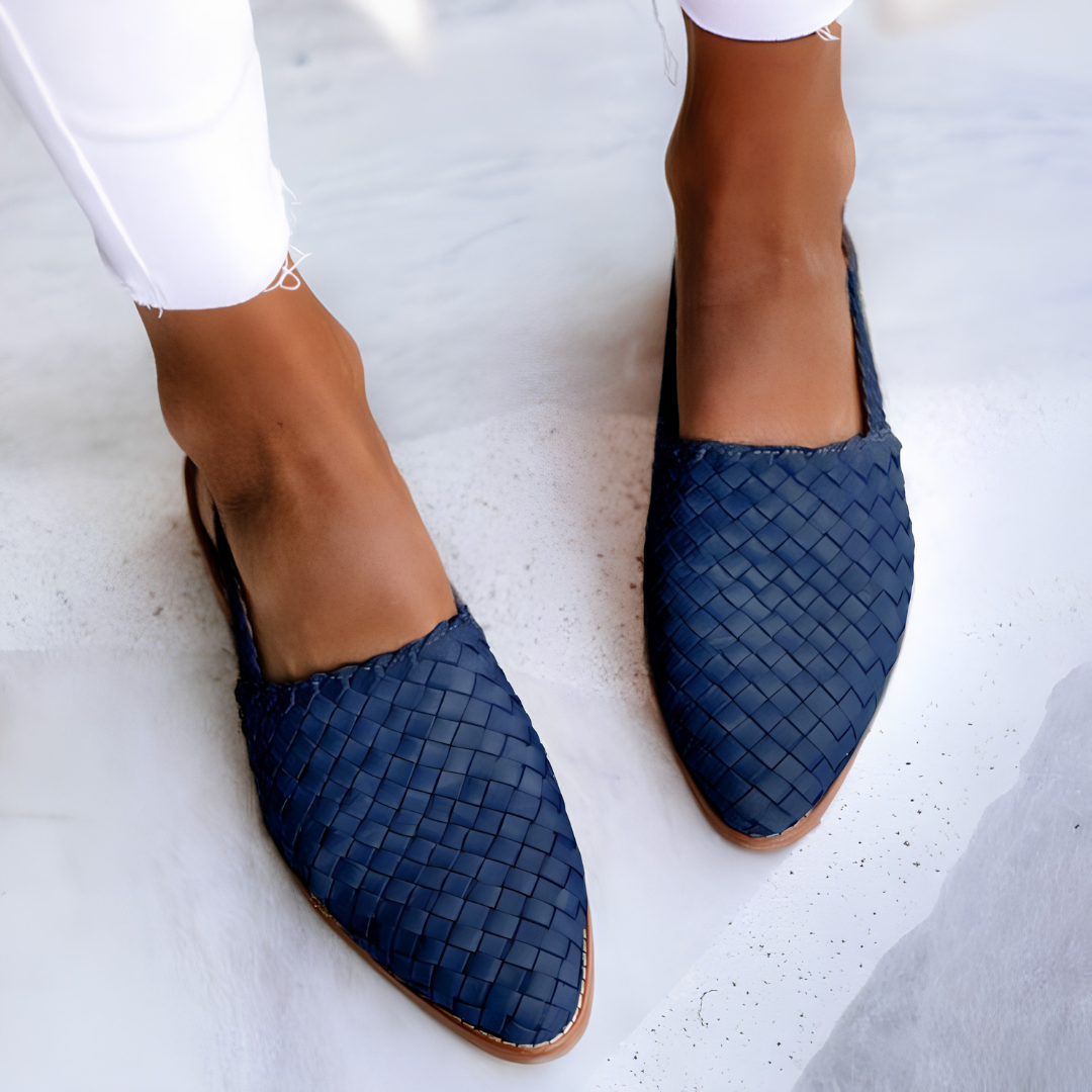 Overhead view of blue handcrafted moccasins arranged neatly, focusing on the vibrant color and slip-on design.