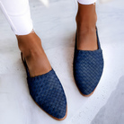 Overhead view of blue handcrafted moccasins arranged neatly, focusing on the vibrant color and slip-on design.