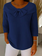 Texture shot of the knit fabric from the elegant knitted top, showing the soft feel and quality of the material.