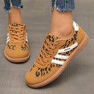 Lifestyle shot of a woman wearing off-white Elara orthopaedic cushioned trainers while walking outdoors, showing comfort in motion.