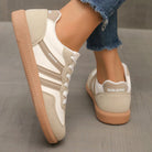 Side view of a black Elara orthopaedic cushioned trainer, highlighting its streamlined silhouette and supportive heel.