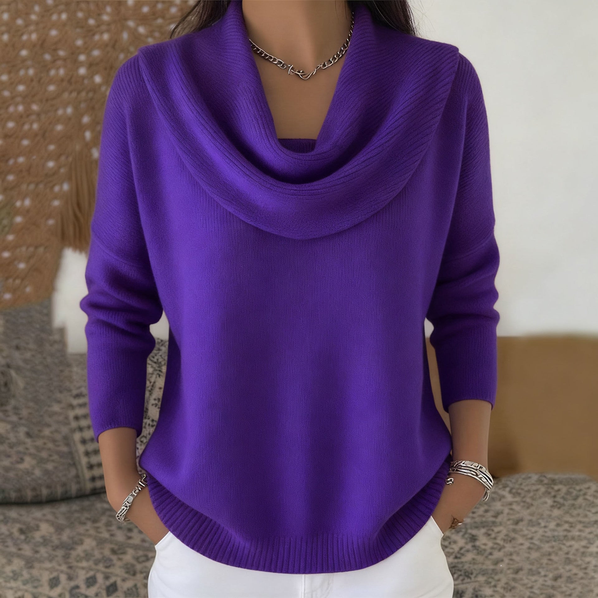 Lifestyle shot of Elina comfort fit pants in brown, paired with a sweater for a cozy, elegant look.