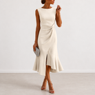 Styling suggestion for the draped midi dress with a clutch and sandals, ready for a wedding guest look.