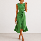 Model posing in a navy blue draped midi dress, demonstrating its comfortable fit and refined style for special events.