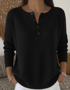 Full-length shot of the comfortable button-up pants styled with a casual top and shoes.
