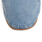 A close-up of the black denim flat cap texture, illustrating the durable and soft feel of the material.