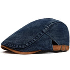 Close-up detail of the denim fabric on the flat cap, revealing its rich texture and quality stitching.