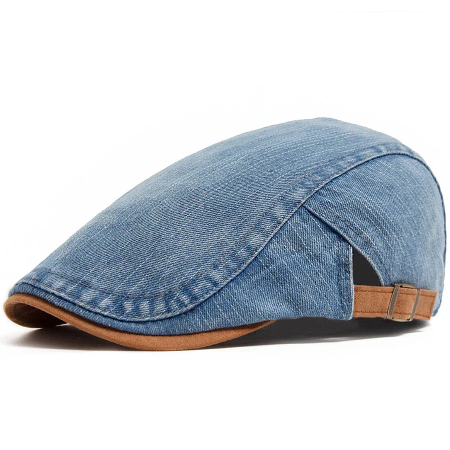 A man wearing the light blue denim flat cap, styled casually outdoors with a relaxed expression.