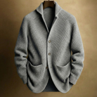 Hand in the front patch pocket of the Florian cardigan, demonstrating the practicality and size of the pockets.