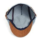 Lifestyle image of the denim flat cap paired with a smart-casual outfit, adding a touch of sophistication.
