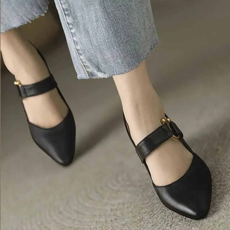 Close-up detail of the smooth brown leather upper on a slingback heel, showcasing its fine texture.