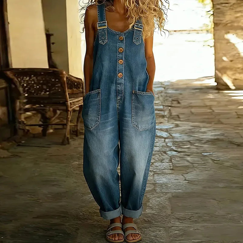 Side view of the Hadley soft denim overalls in blue, demonstrating the comfortable drape and silhouette while standing.