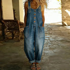 Side view of the Hadley soft denim overalls in blue, demonstrating the comfortable drape and silhouette while standing.