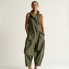Lifestyle image of the black sleeveless jumpsuit styled with accessories for a warm evening out.
