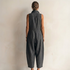 Rear view of the black sleeveless jumpsuit, emphasizing the clean lines and relaxed fit.