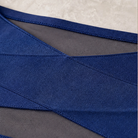 Stack of assorted color high-waisted shaping underwear (blue, black, nude, pink) neatly arranged.