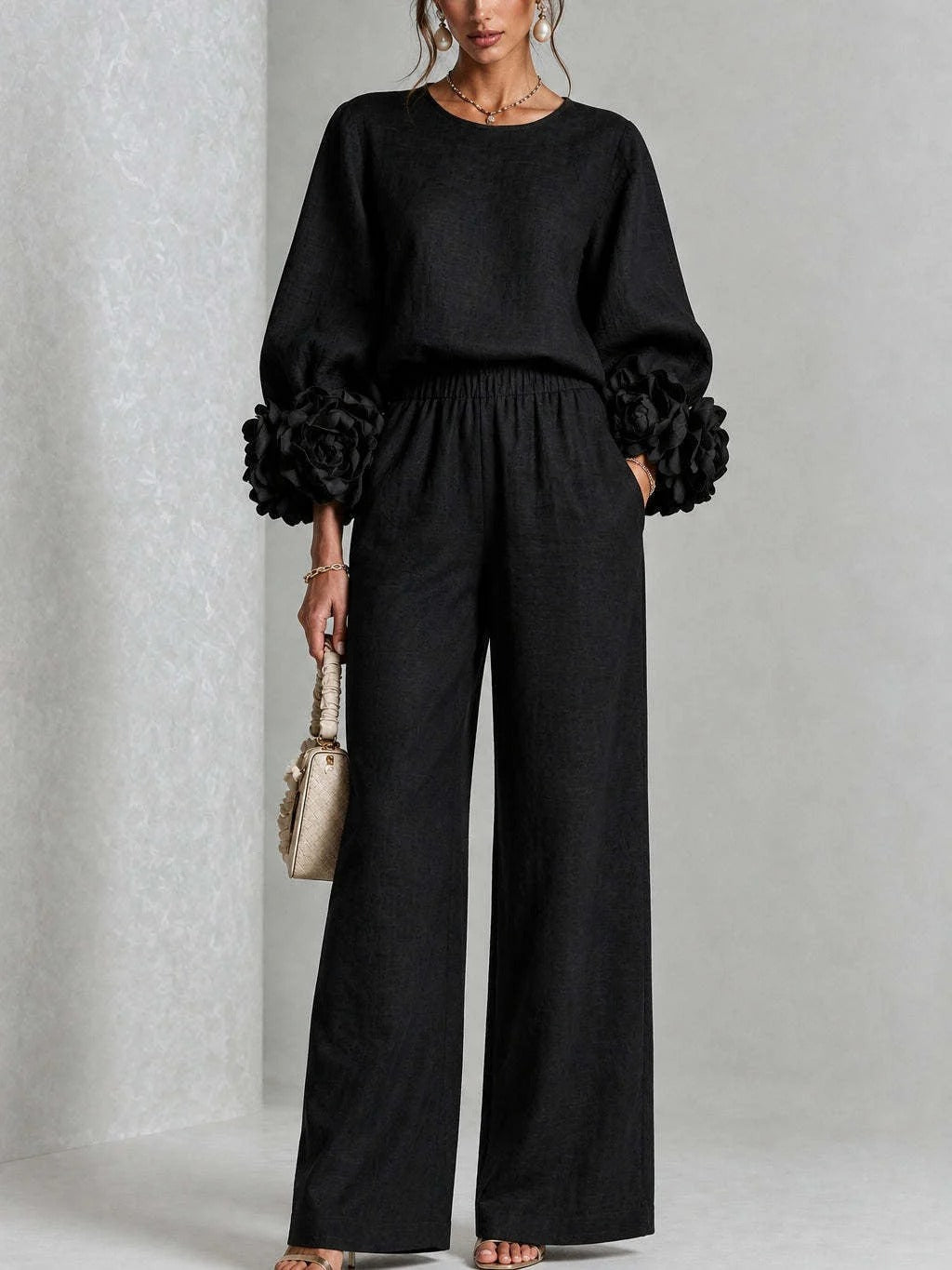Detailed fabric texture of pink wide-leg trousers, showing the quality and soft feel of the material.