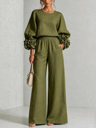 Model walking in yellow wide-leg trousers, illustrating the beautiful flow and lengthening effect of the design.