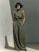 Professional studio shot of the blush pink wide-leg trousers, highlighting the breathable fabric texture.